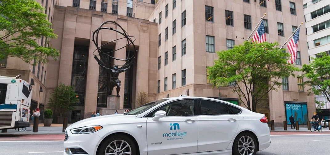 A self-driving vehicle from Mobileye’s autonomous test fleet passes by the Atlas statue in Rockefeller Center in June 2021.