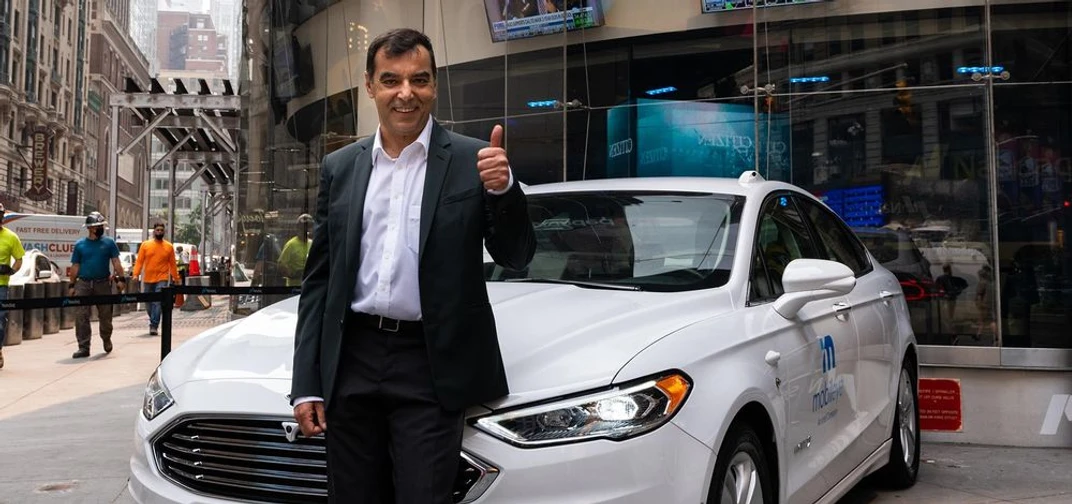Professor Amnon Shashua, president and CEO of Mobileye, stands with a self-driving vehicle from Mobileye’s autonomous test fleet outside the Nasdaq in New York.