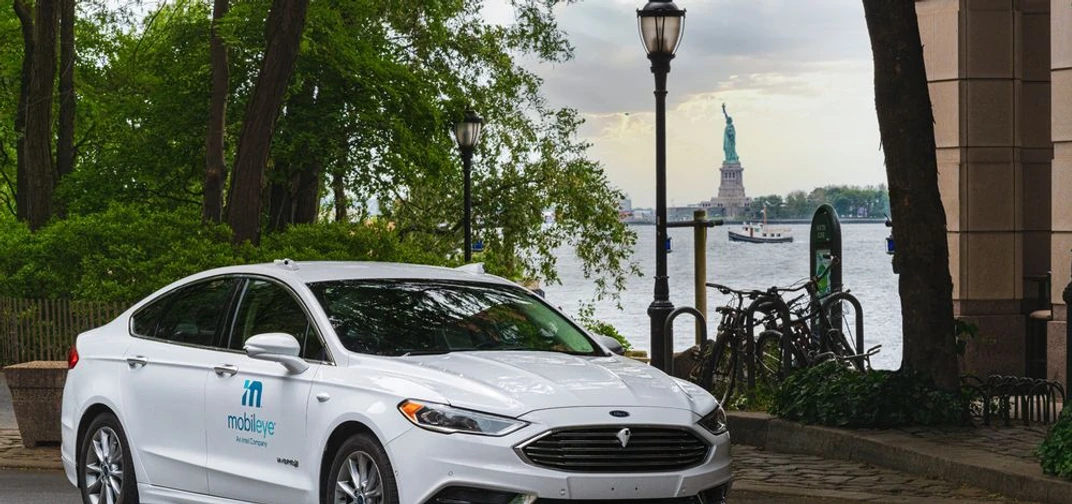 A self-driving vehicle from Mobileye’s autonomous test fleet sits parked across from the Statue of Liberty in June 2021.