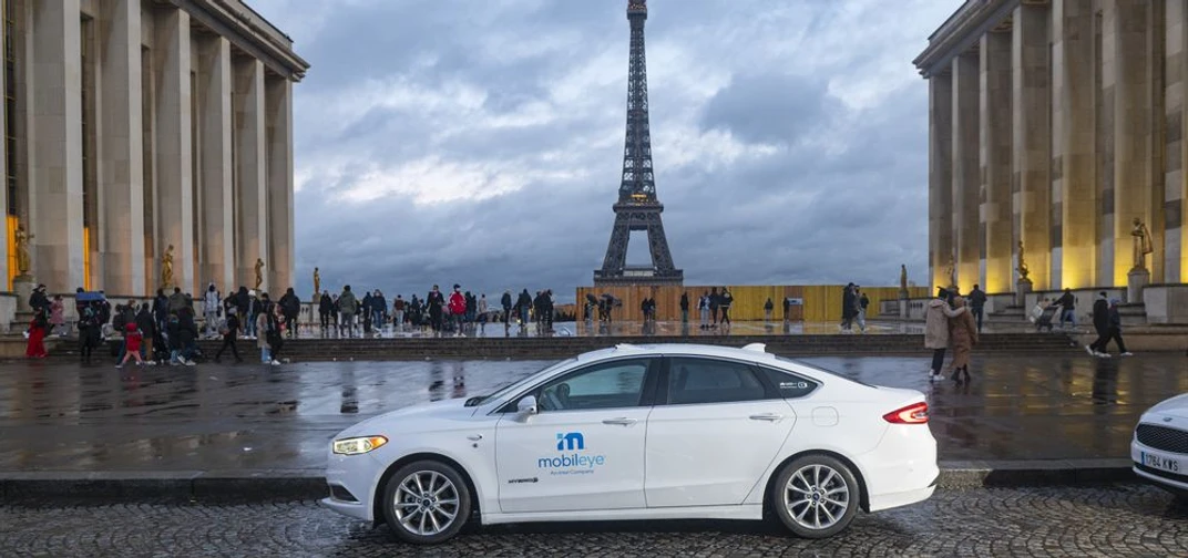 A photo shows a self-driving vehicle from Mobileye’s autonomous fleet in front of the Eiffel Tower in Paris. (Credit: Mobileye)