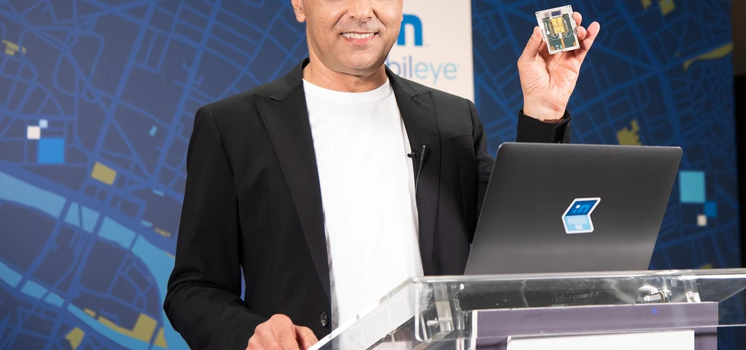 During his annual "Under the Hood" address at the all-virtual CES 2021, Prof. Amnon Shashua, president and CEO of Mobileye, shows off a new silicon photonics lidar SoC that will deliver frequency-modulated continuous wave (FMCW) lidar on a chip for autonomous vehicles beginning in 2025. (Credit: Intel Corporation)